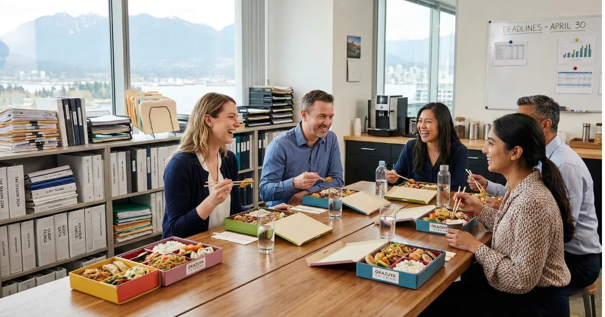Accountants working at desks during tax season with catered lunch boxes delivered to their office